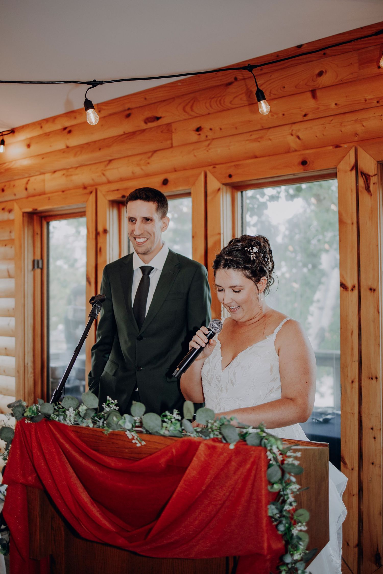 A series of wedding ceremony photos showing a couple signing documents in a rustic wooden cabin setting.