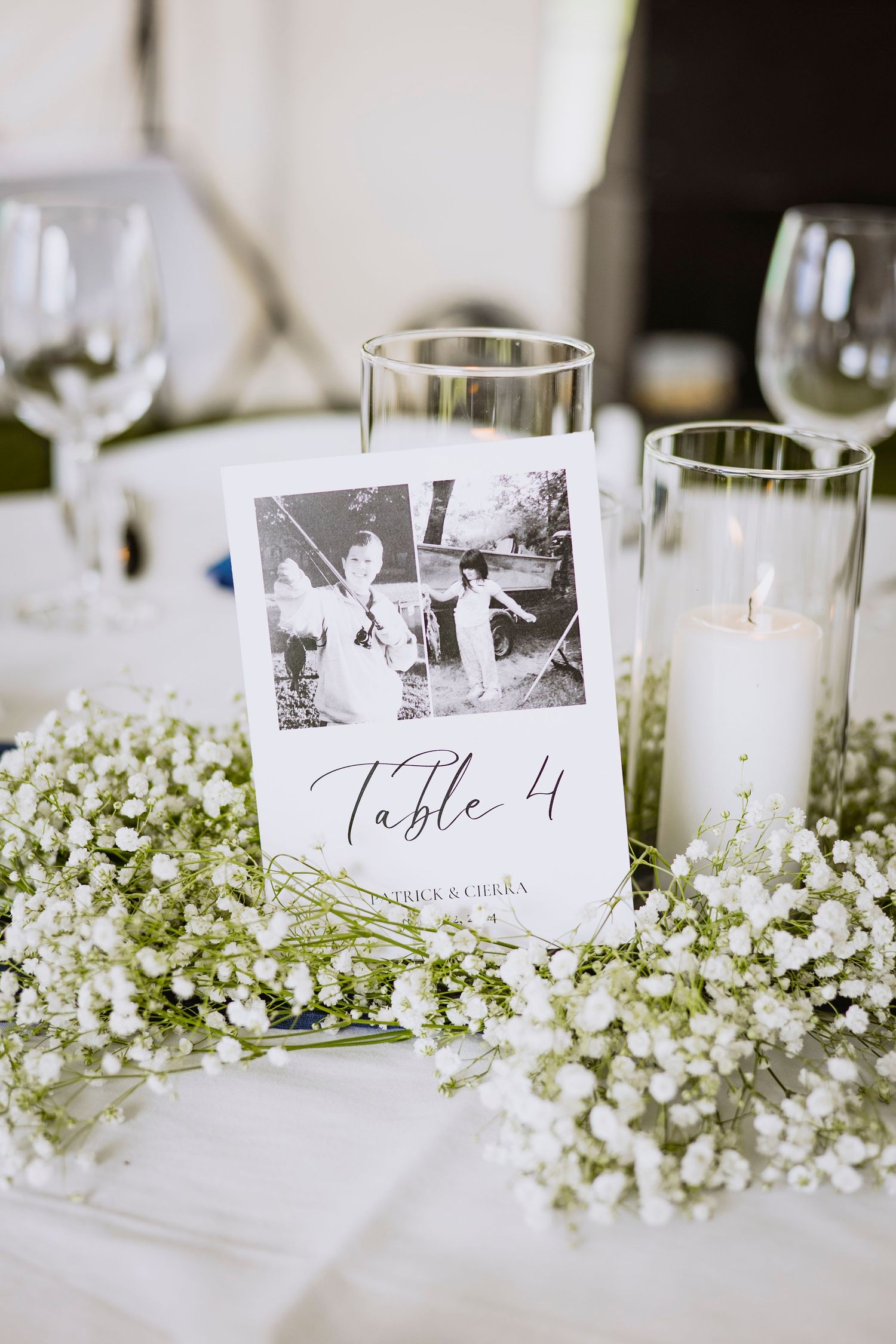 Table number display with vintage photo and baby's breath flowers at wedding reception.