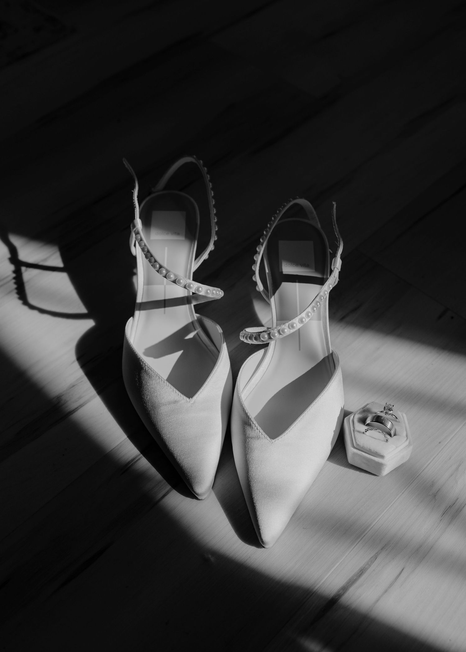 A sequence of six black and white photos showing dramatic shadows cast by a small paper sculpture on a surface.