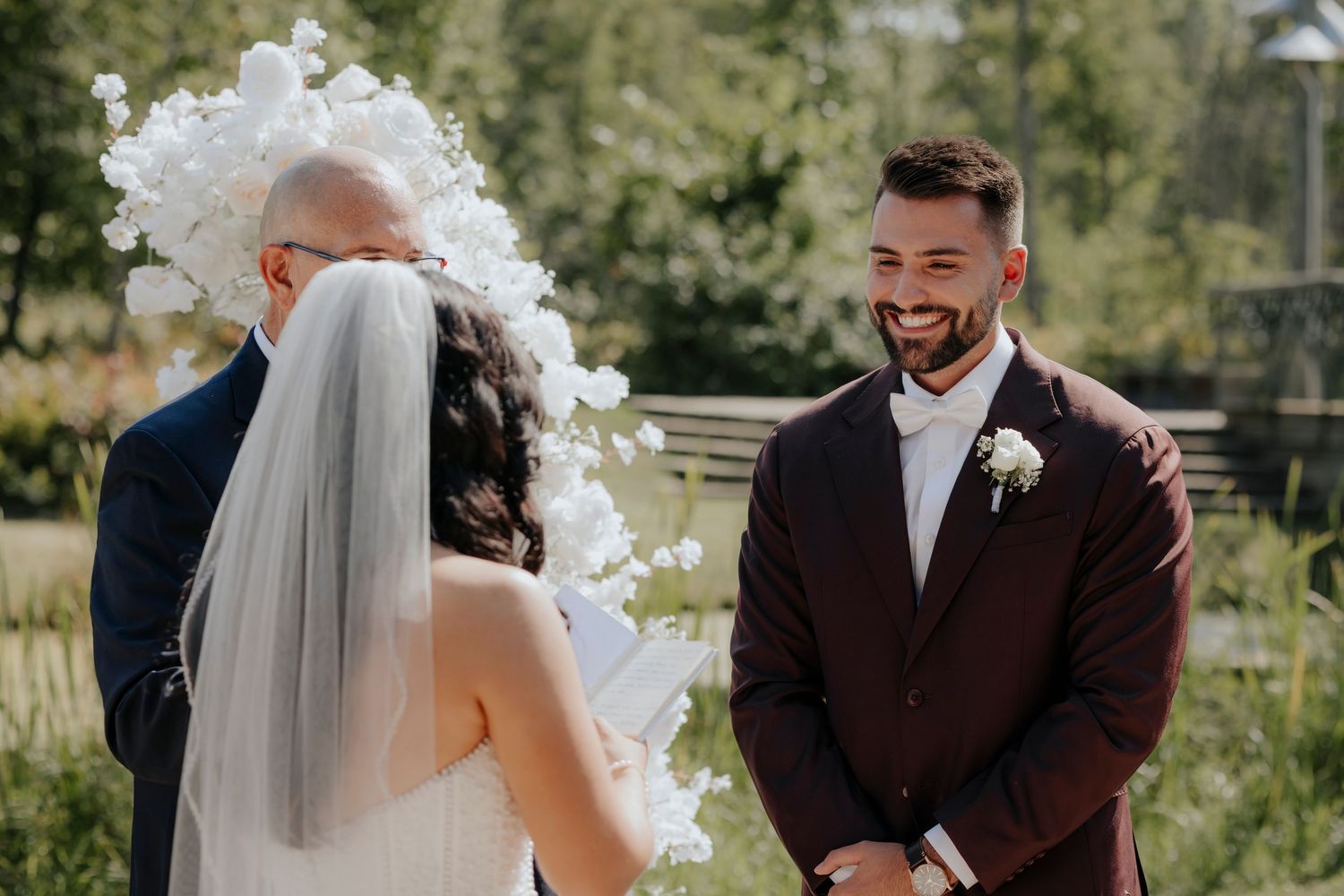 An outdoor wedding ceremony moment showing emotional reactions during vows.