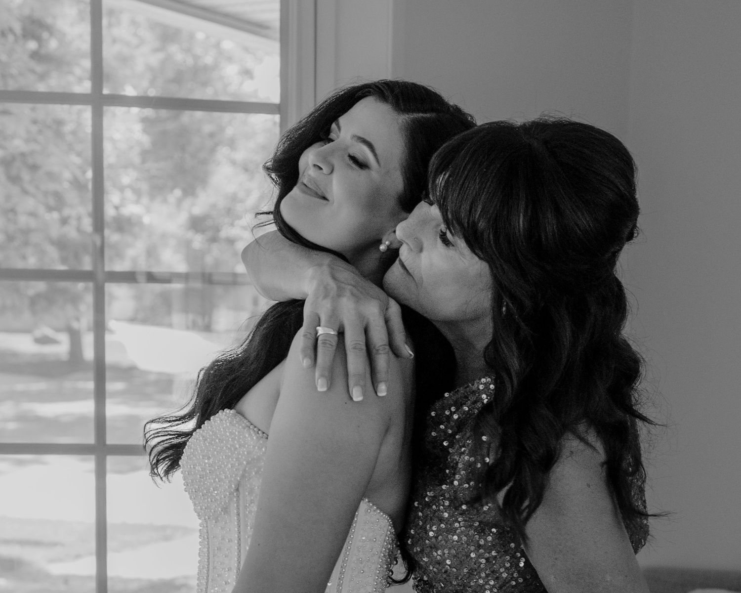 Black and white photo series showing tender moments of a romantic embrace between two people in formal attire.
