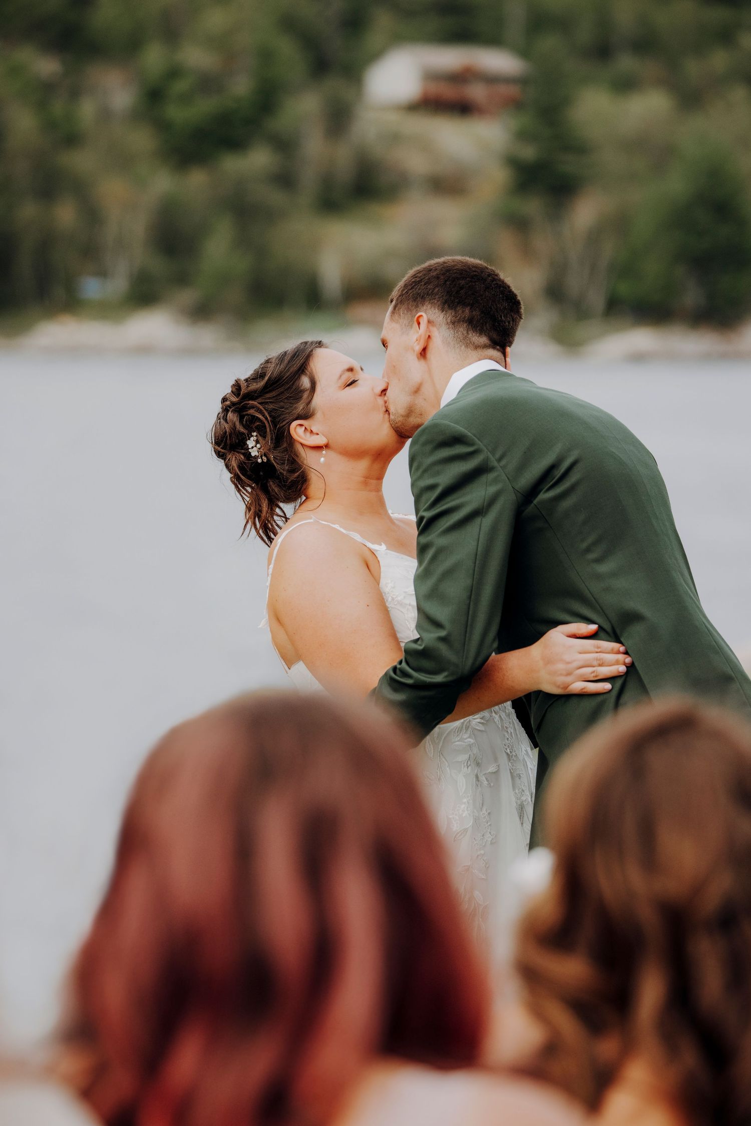 Romantic waterfront wedding ceremony with burgundy-clad bridesmaids in attendance.