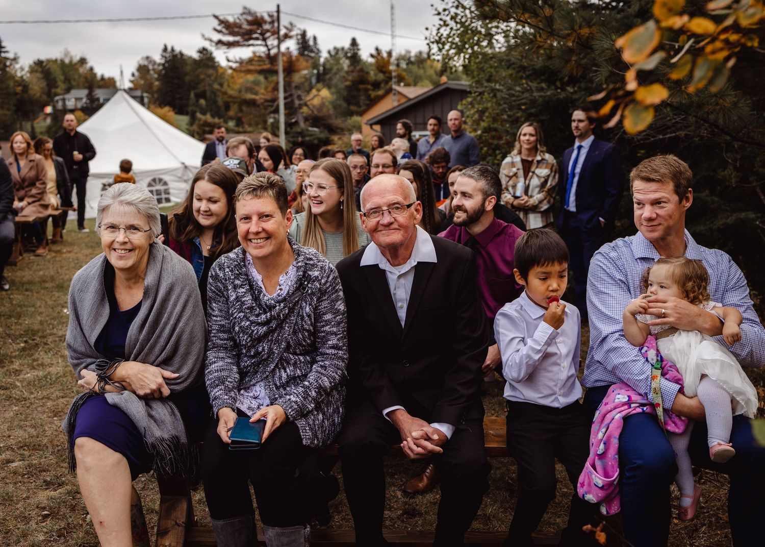 Wedding guests celebrating outdoors during autumn celebration.
