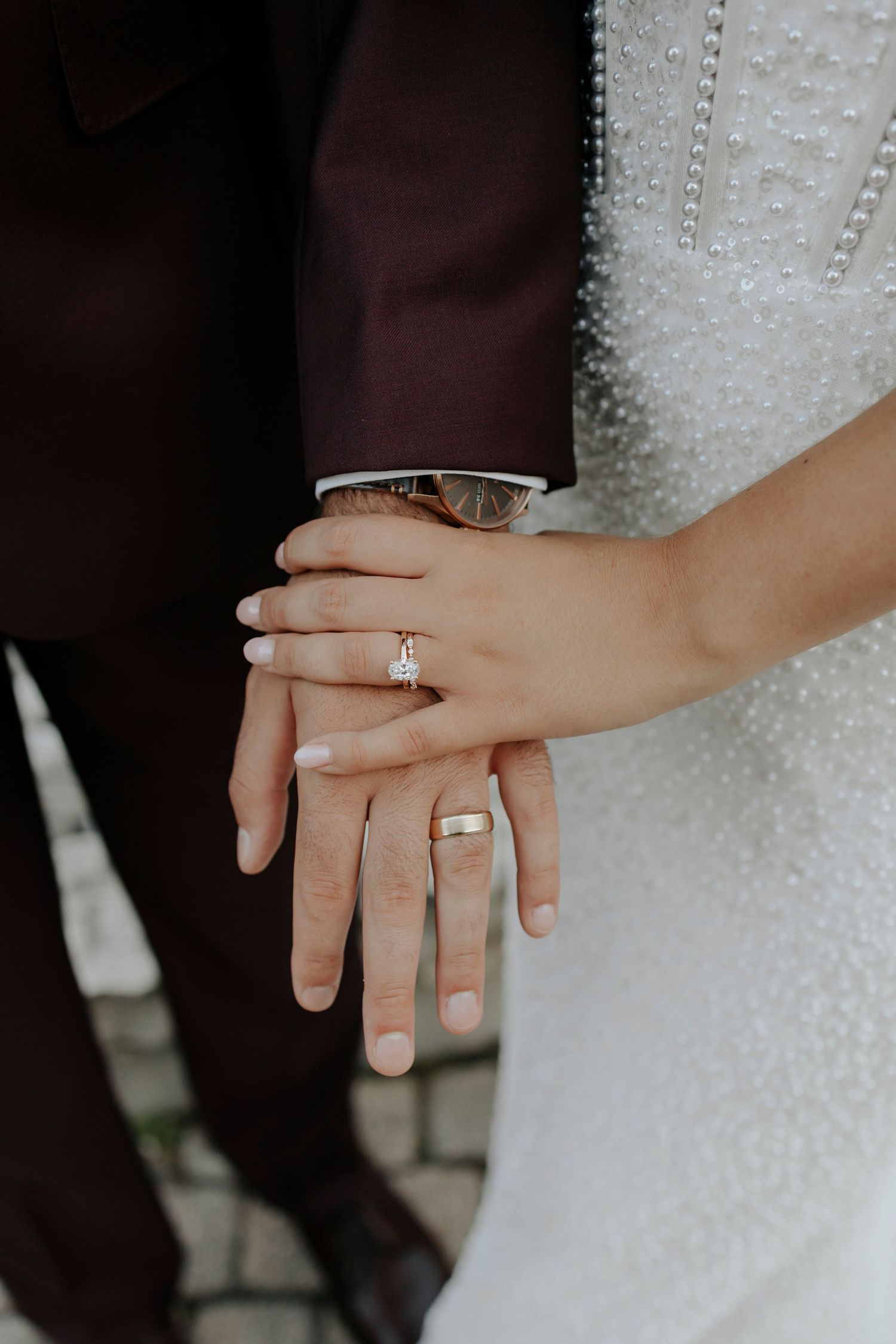 Close-up shots of wedding rings and beaded white dress details.