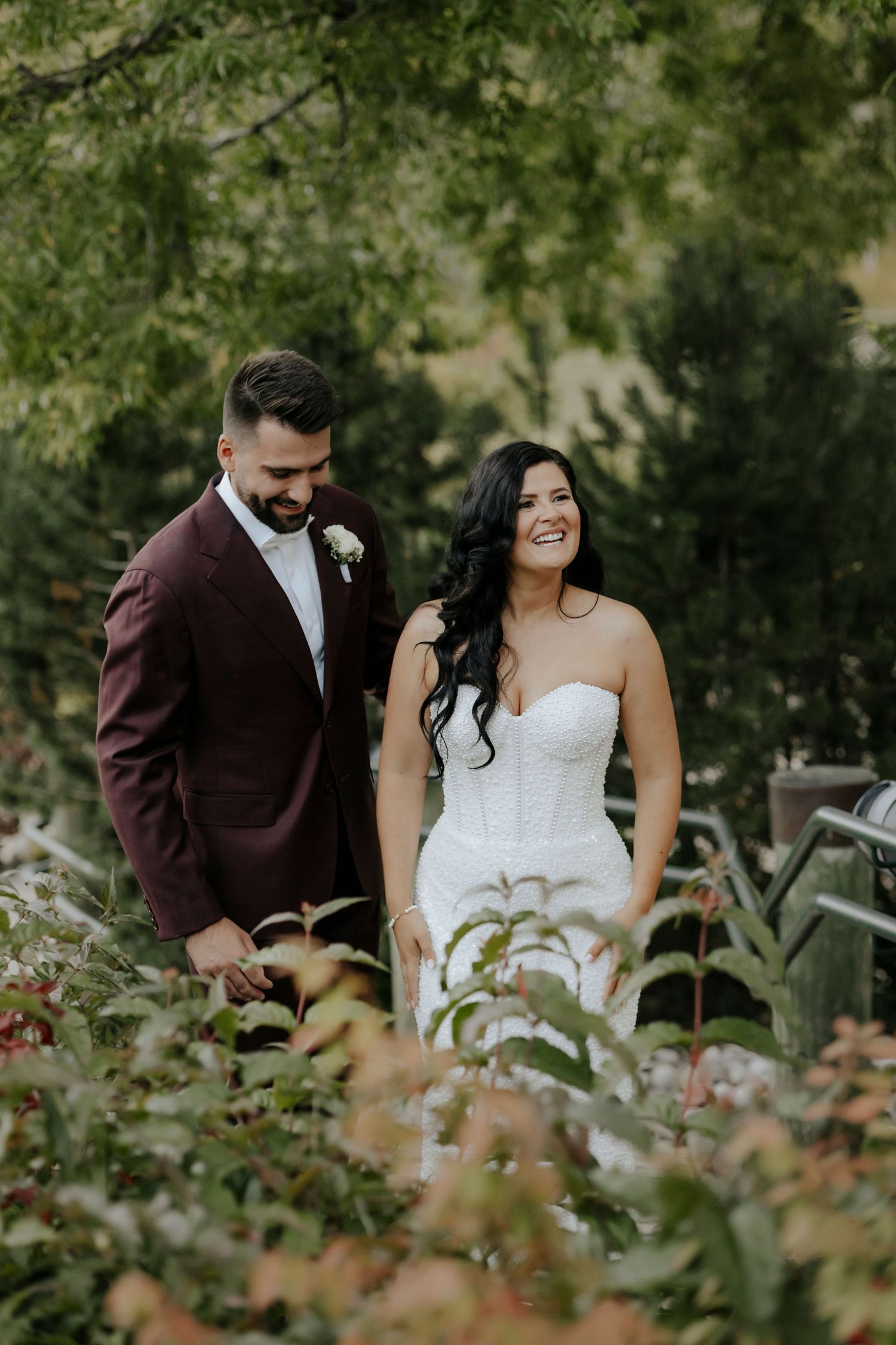 Romantic wedding couple sharing intimate moments in a lush garden setting with soft natural lighting.