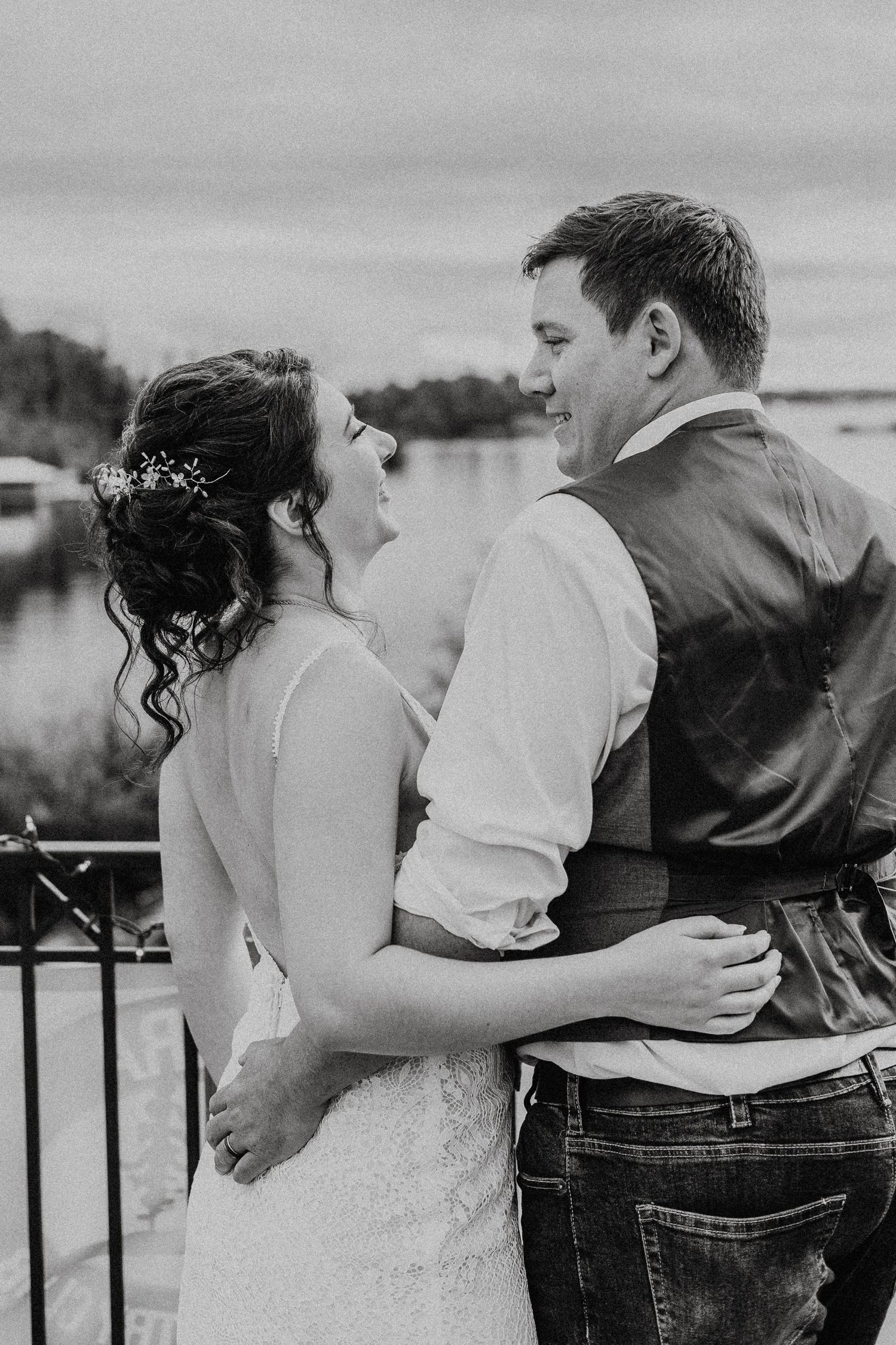 Romantic black and white series showing a couple embracing and kissing on a balcony.