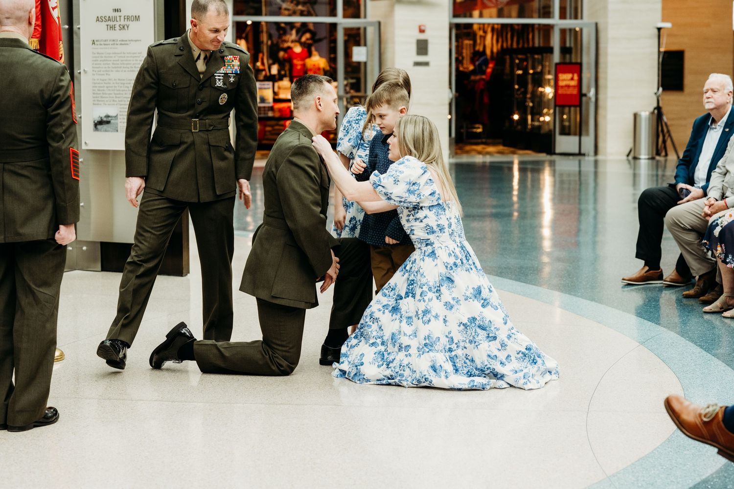 Indoor event photography showing people gathered in formal attire.