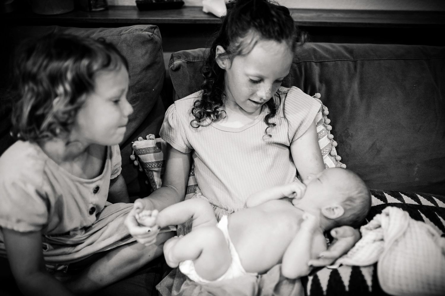 A series of black and white photographs showing tender family moments on a bed.