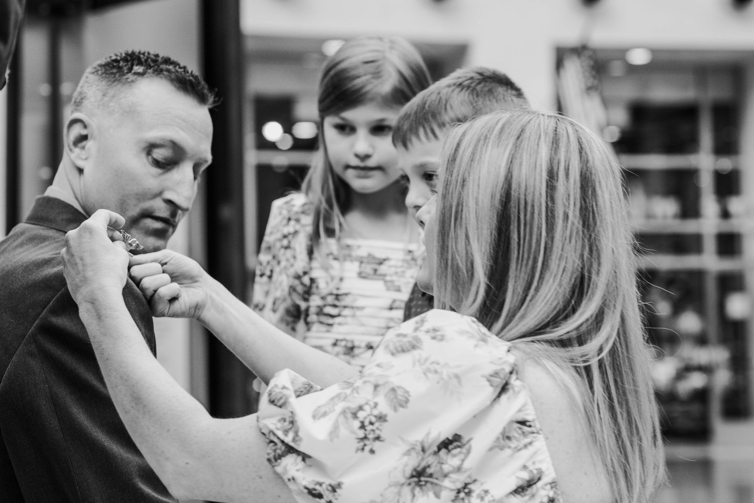Black and white indoor photoshoot capturing intimate moments between loved ones. Military events