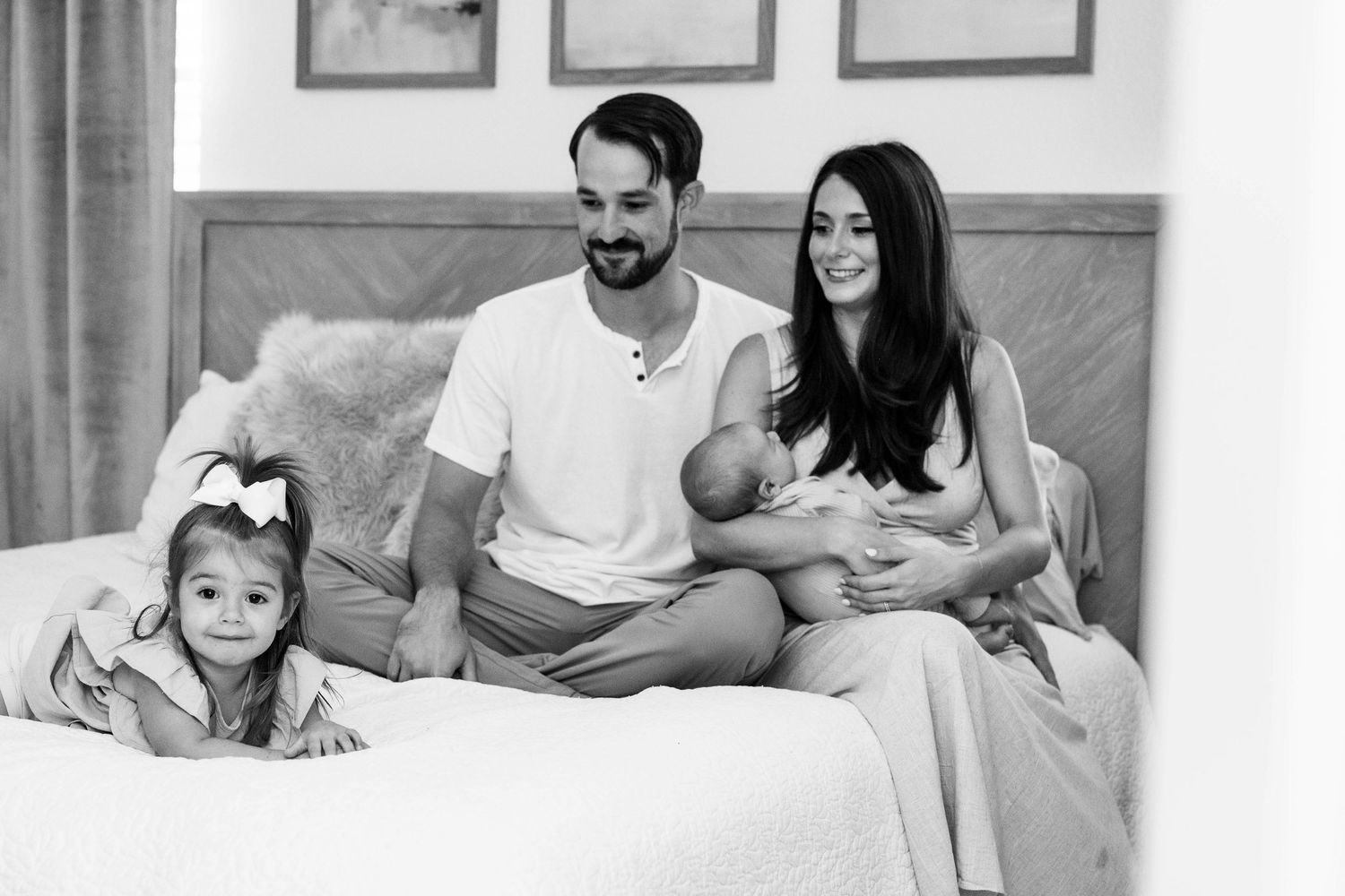 A series of relaxed family portraits in white and neutral tones on a bed with natural lighting.