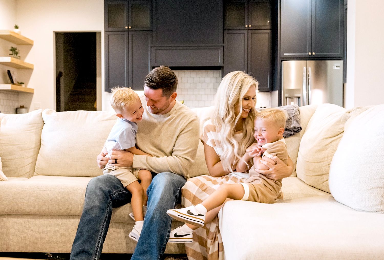 A family relaxes together on a comfortable sectional sofa in their living room.