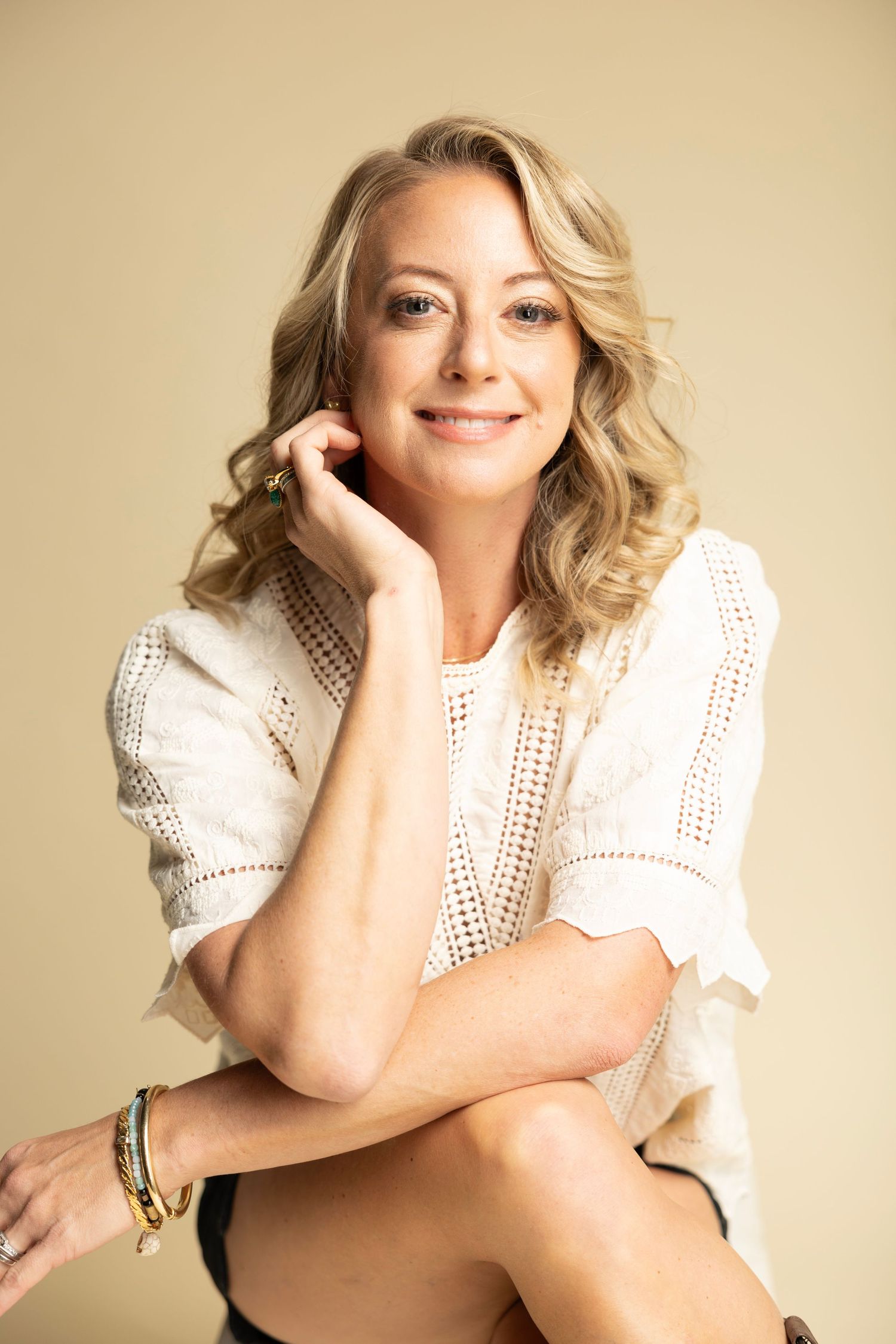 A series of glamour portraits showing a person in a white lace top posing against a neutral background.