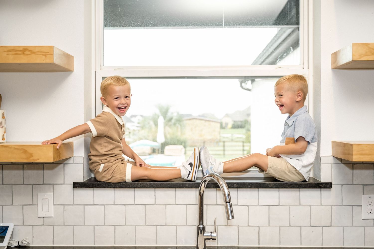 A sequence of photos showing a baby sitting on a kitchen counter near a sink with white subway tile backsplash.