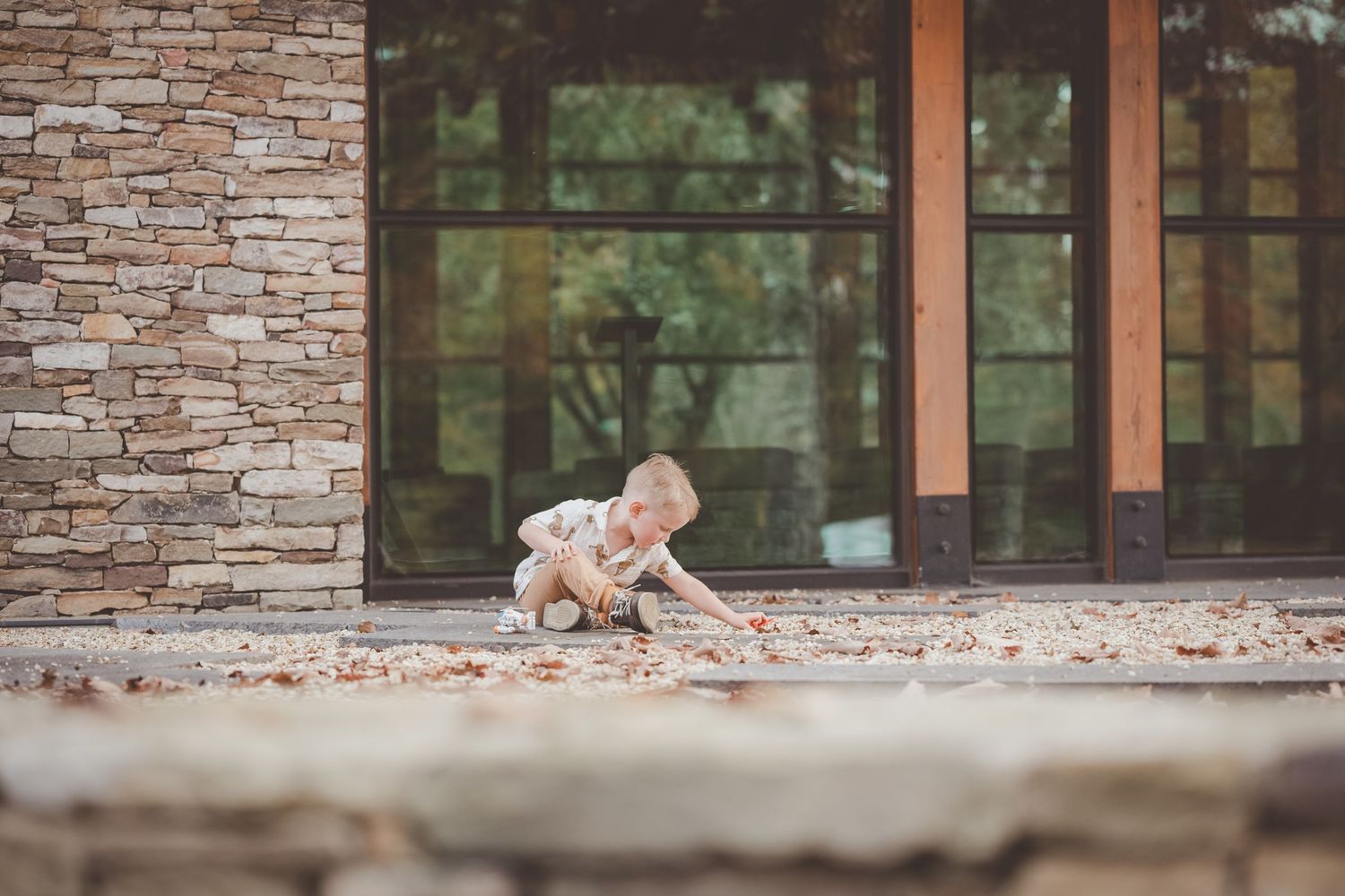Stone building exterior with large windows creates an architectural backdrop for outdoor photography.