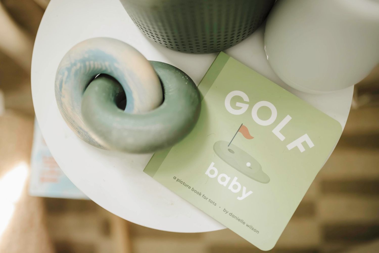 Medical paperwork and soft focus baby products in muted green tones.