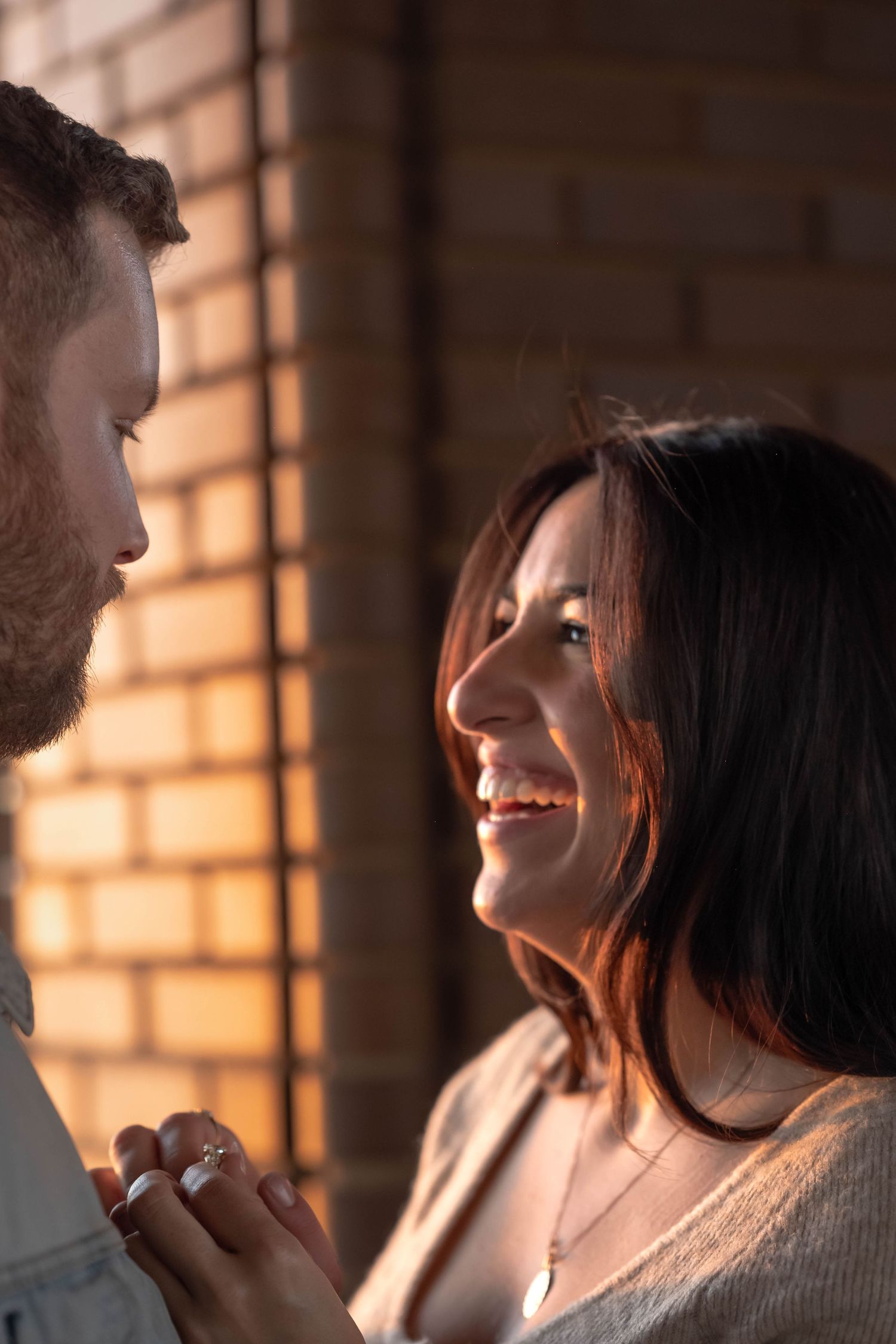 A romantic couple shares intimate moments in warm sunlight streaming through a window.