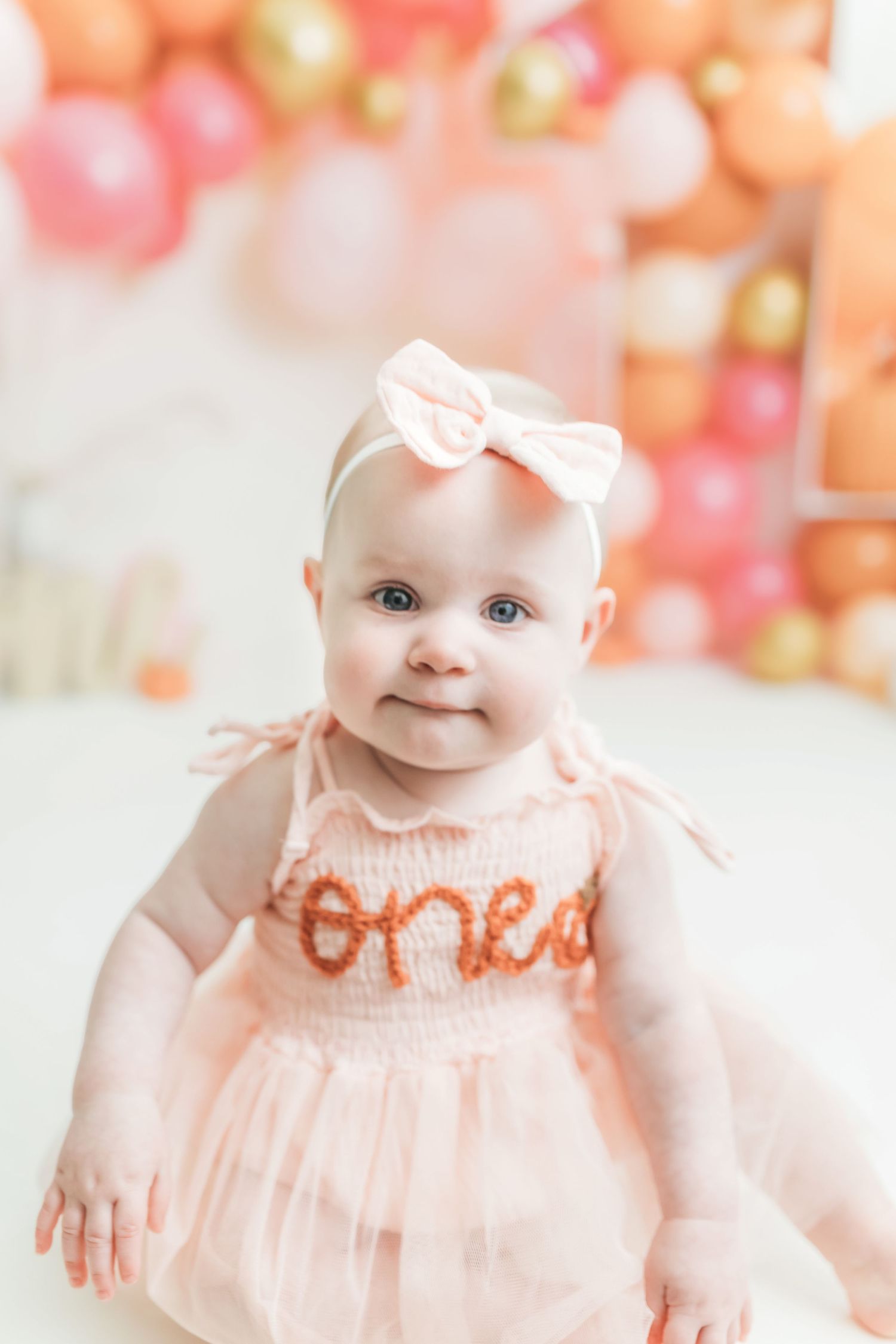 A baby girl in a pink tutu dress with \