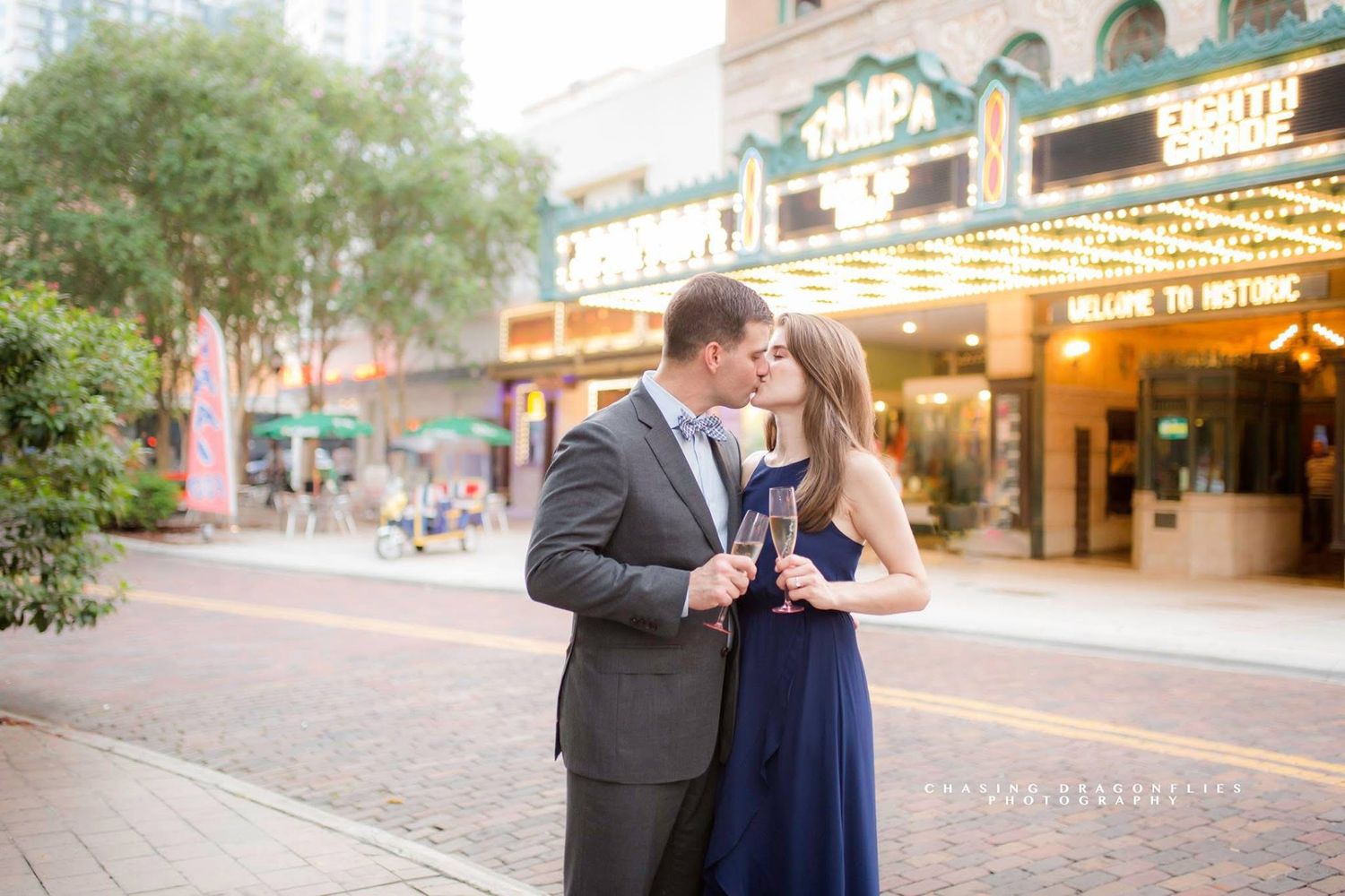 Urban engagement photos taken along city streets with vintage architecture and storefronts.