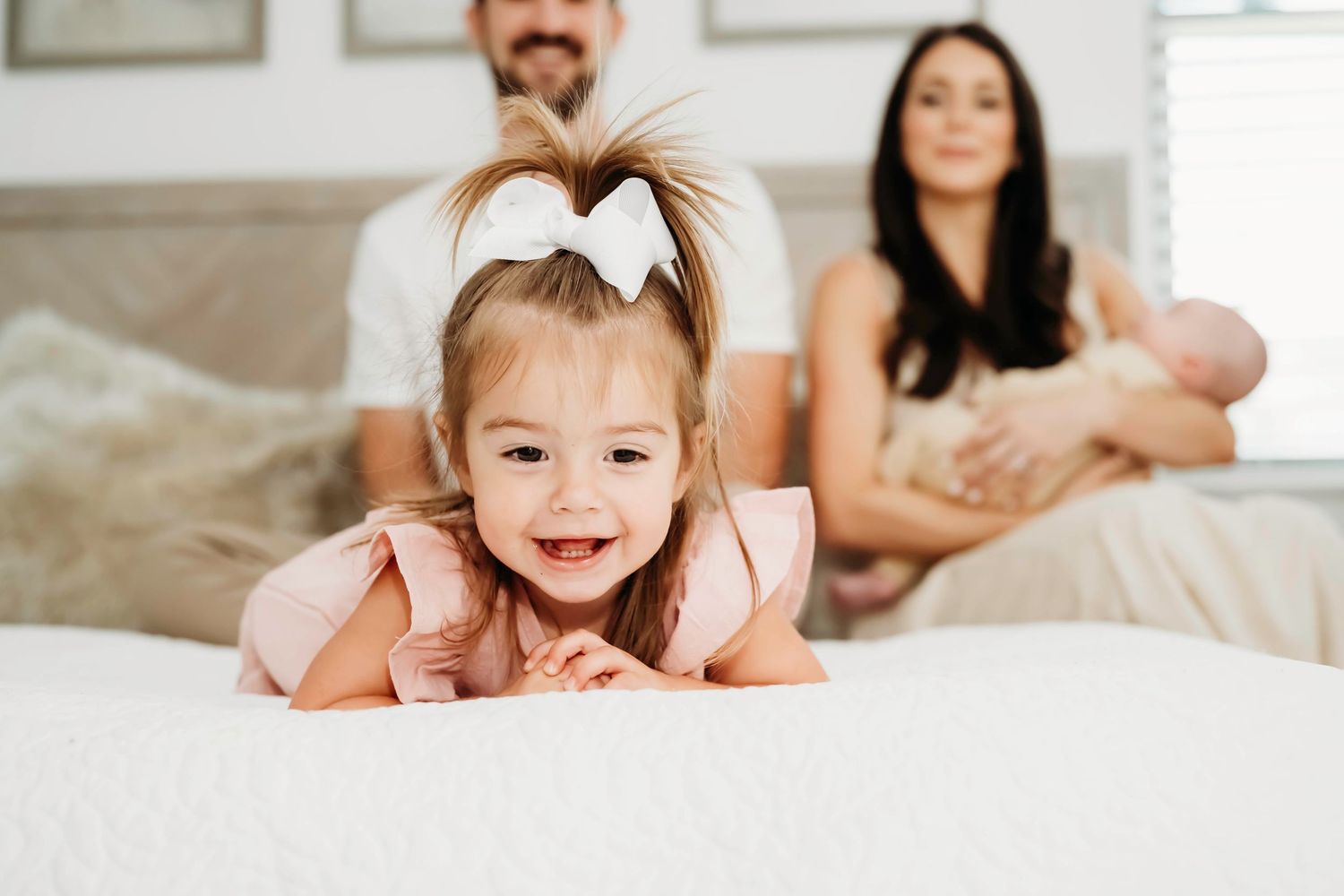 Indoor lifestyle family photos captured on a comfortable couch with natural lighting.