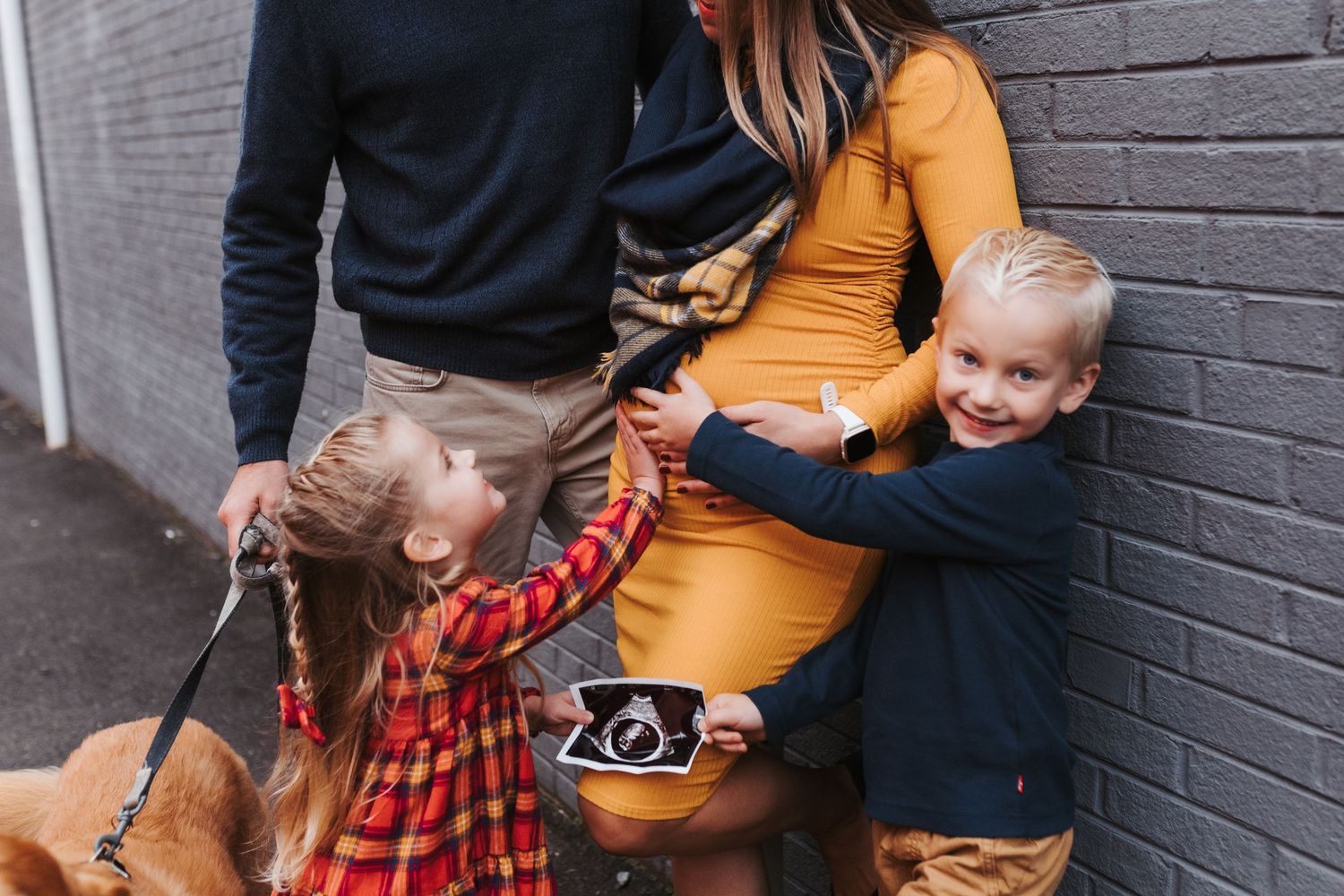 Casual family portraits against grey brick wall with yellow and plaid outfits. Maternity. Northlake, Argyle TX