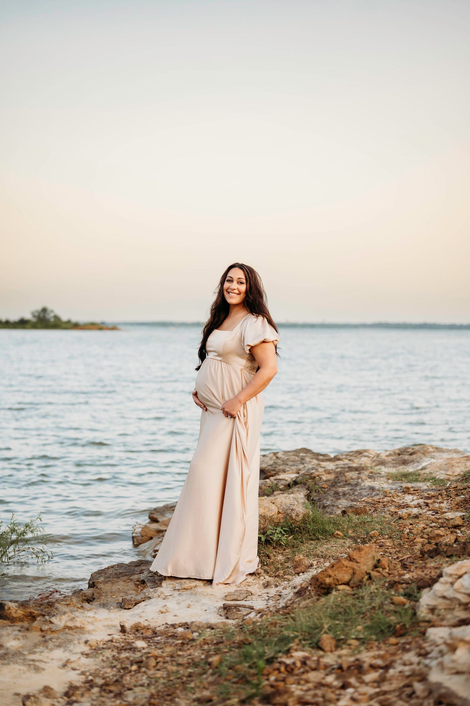 A series of dreamy beach portraits showing someone in a flowing beige dress posing along a rocky shoreline at sunset.