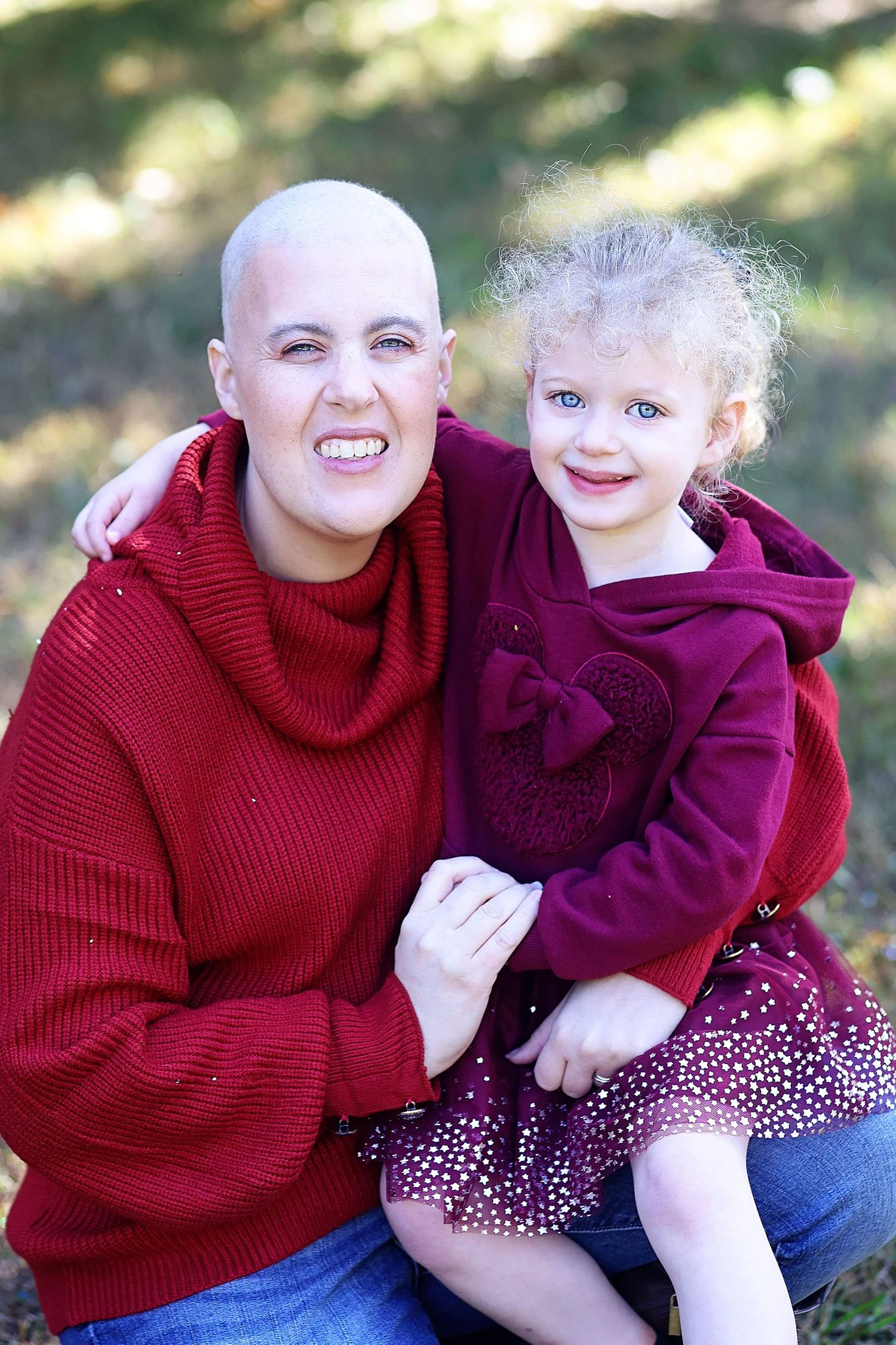 Mother and young daughter smiling together during the mothers cancer treatment.