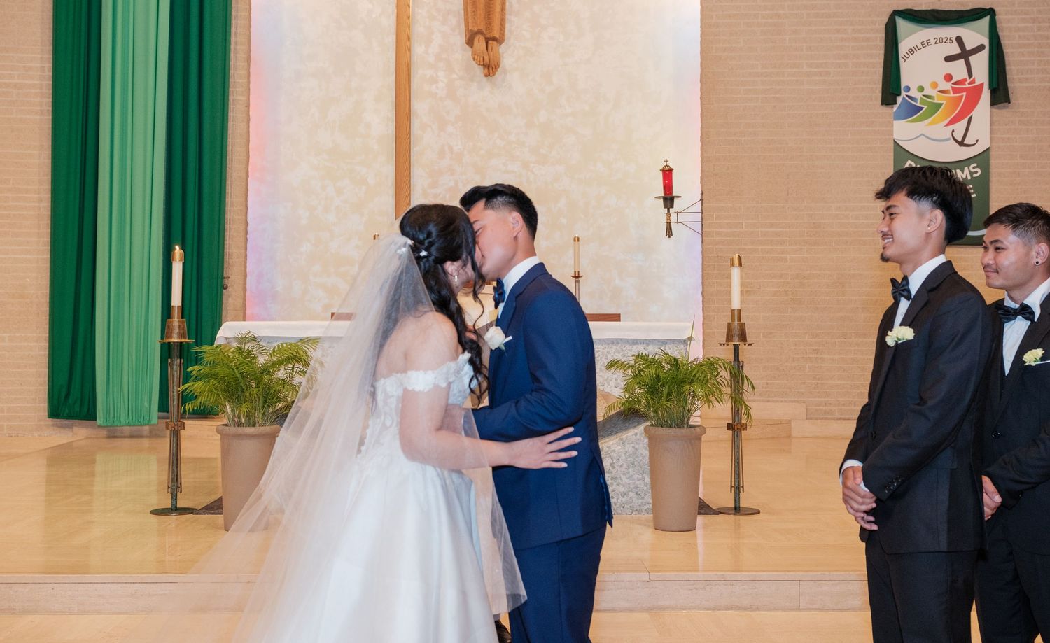 A wedding ceremony taking place in a church with green accents and decorative elements.