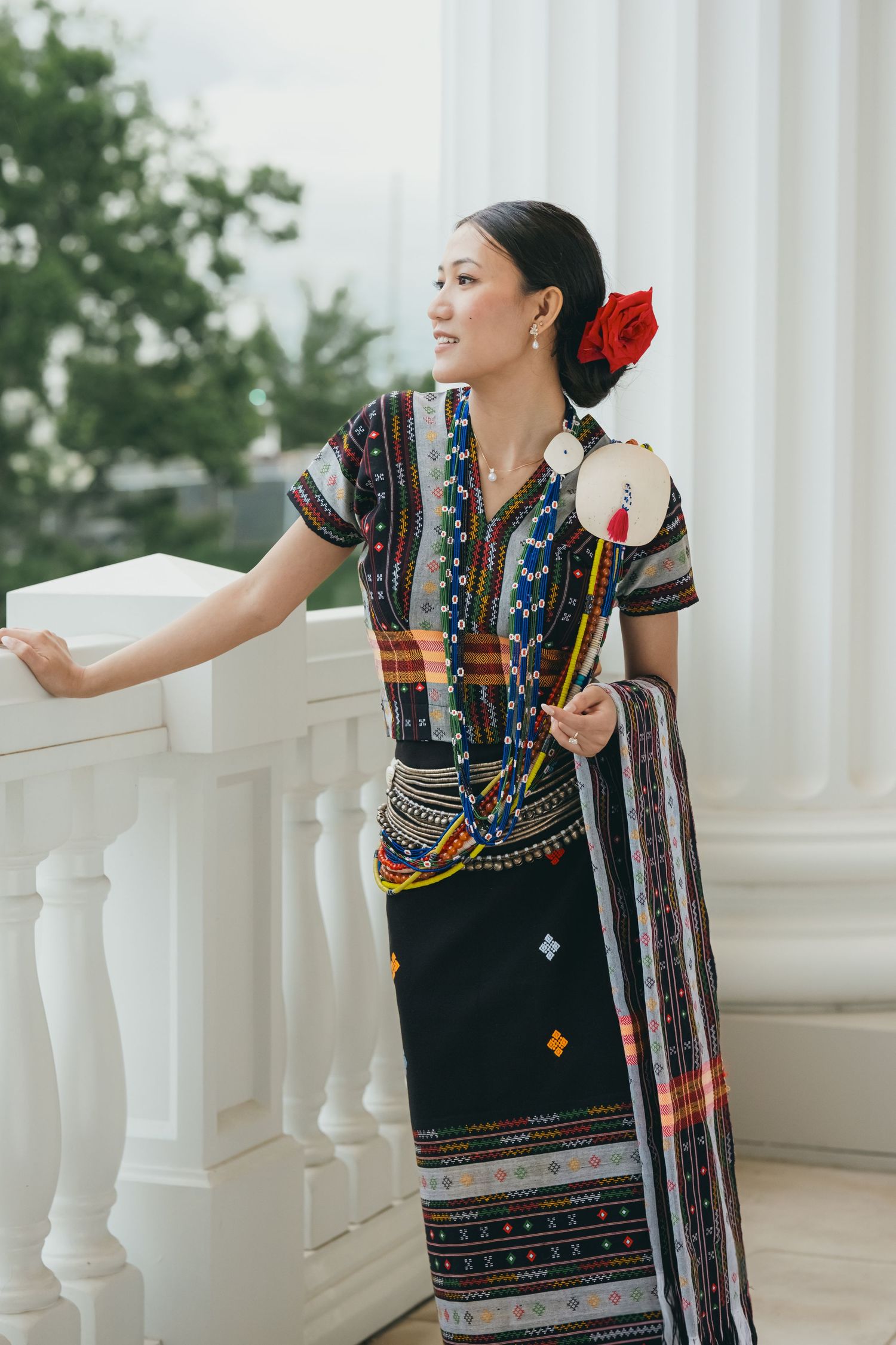 Traditional ethnic attire with colorful embroidery displayed in elegant outdoor setting.