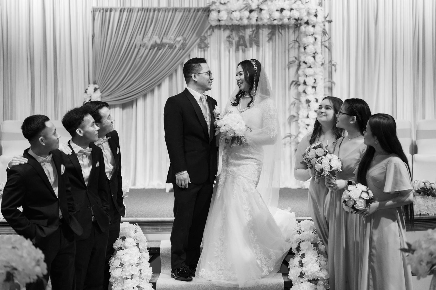 A series of black and white wedding ceremony photos showing intimate moments and celebrations.