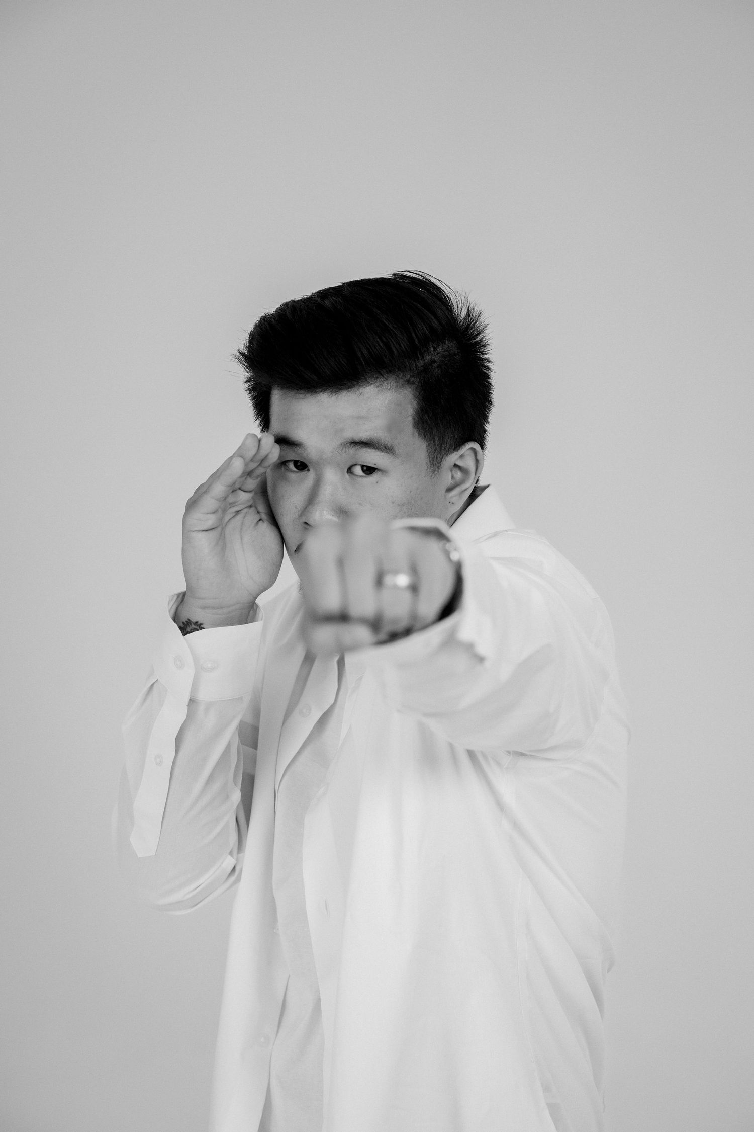 Artistic black and white sequence showing expressive hand gestures in a studio setting.