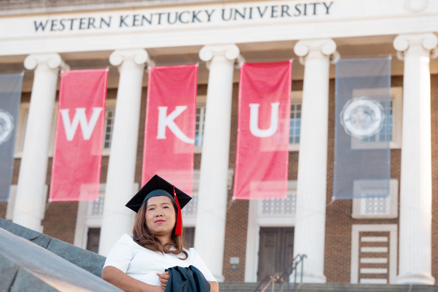 Panoramic view of Western Kentucky University's main building entrance with red banners.