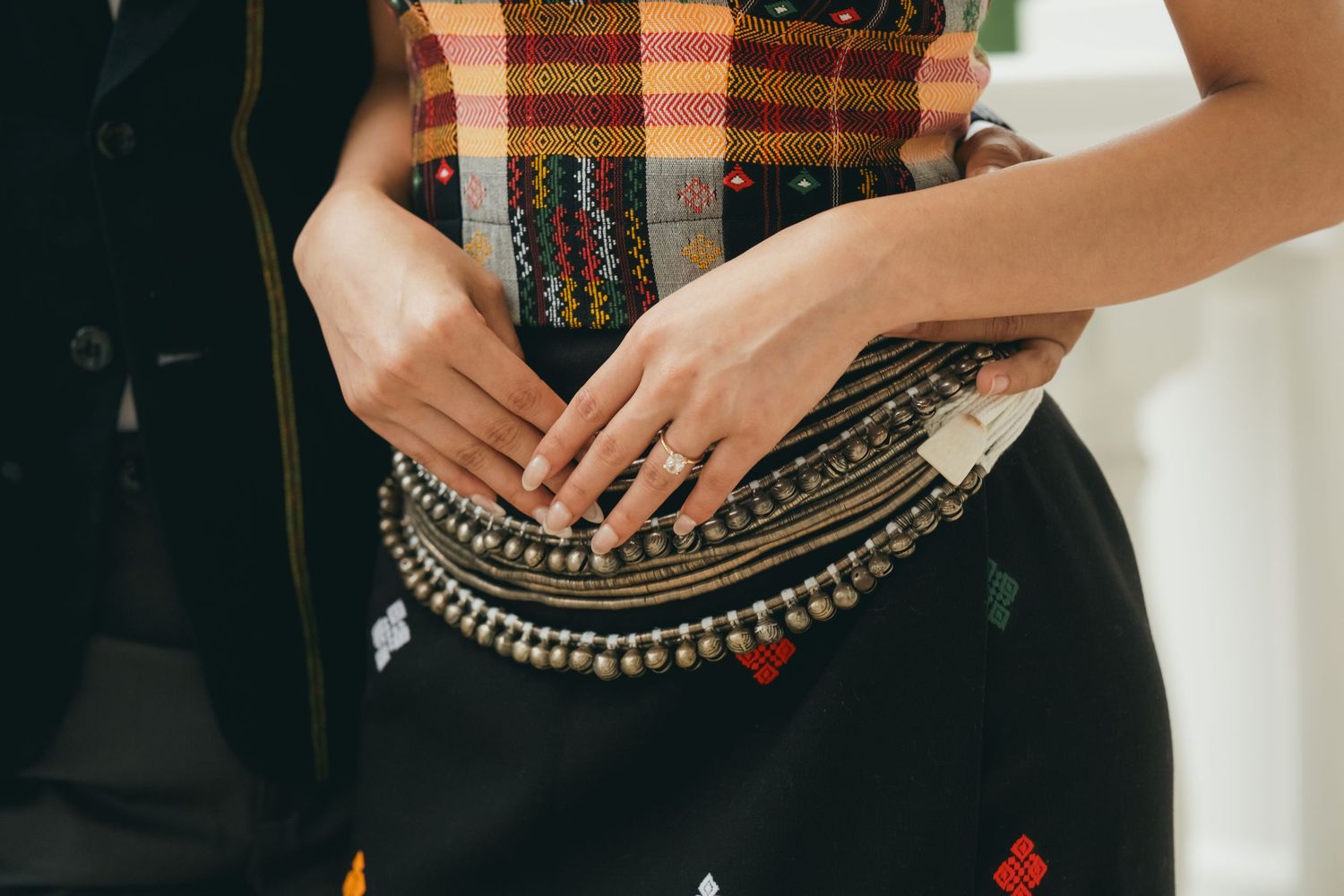 Close-up of intricate details on traditional Hmong clothing and accessories.