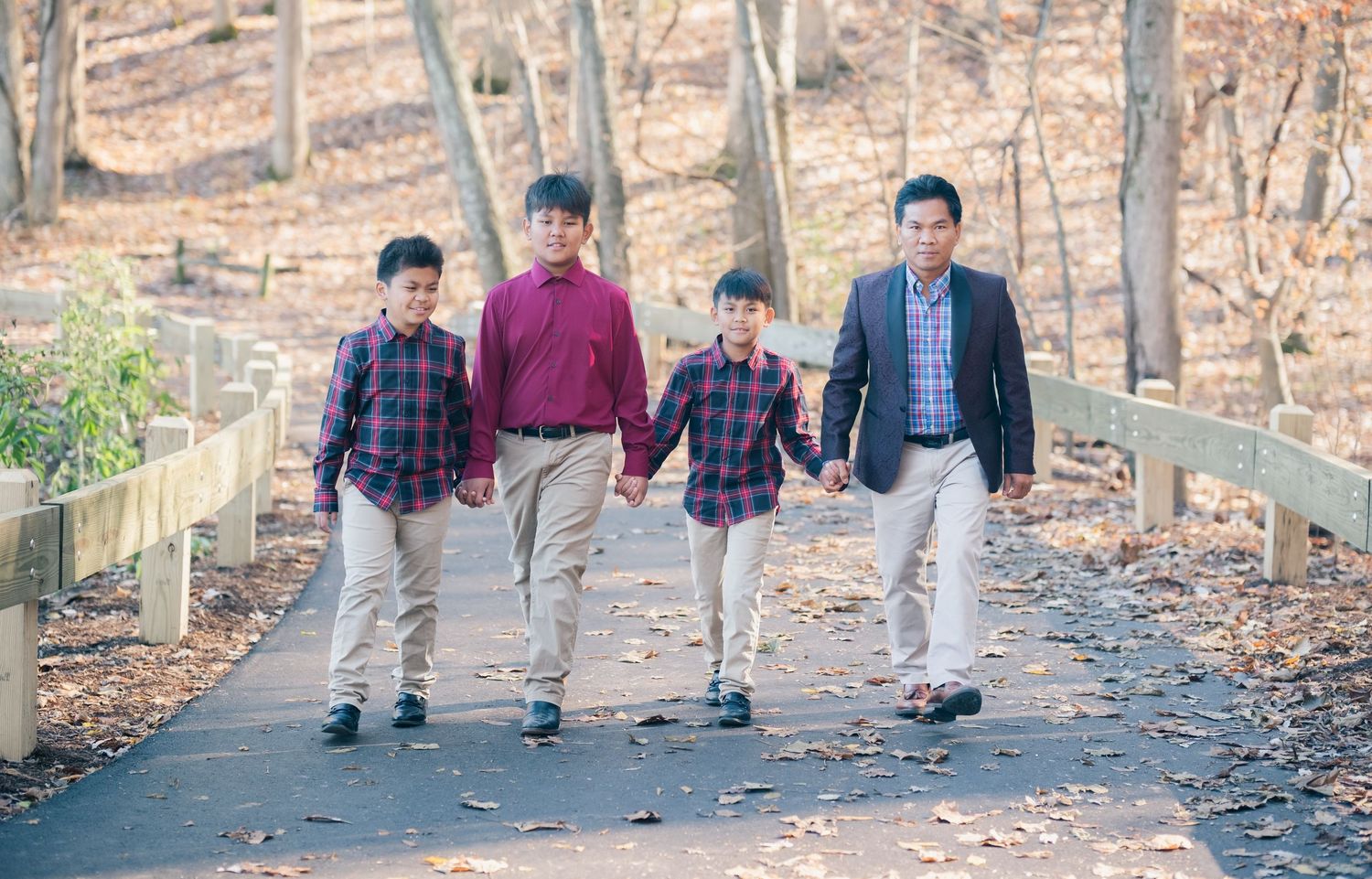 A group walks casually along a winding forest path during autumn.