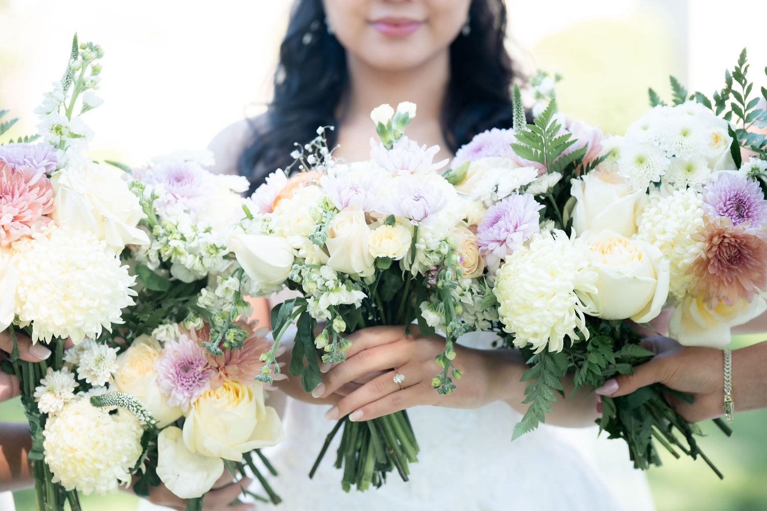 Elegant bridal bouquet featuring white and pink flowers with delicate baby's breath accents.