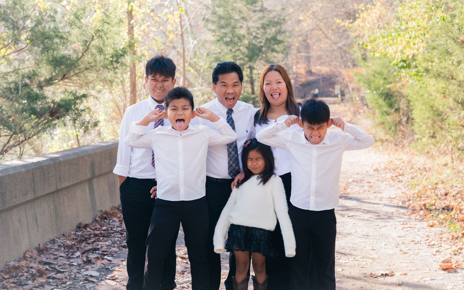 Outdoor family photography on a wooded trail during autumn season.