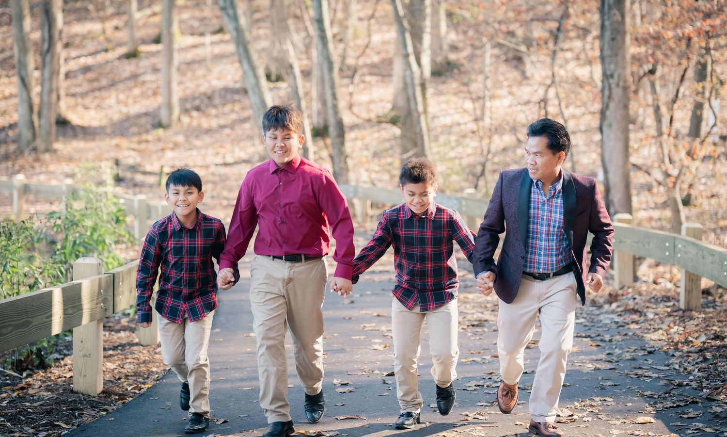 Group walking together on a wooded path during autumn.