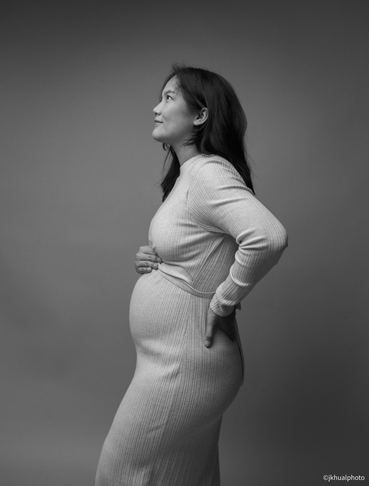 A series of black and white photographs showing a person in a light sweater posing from different side angles.