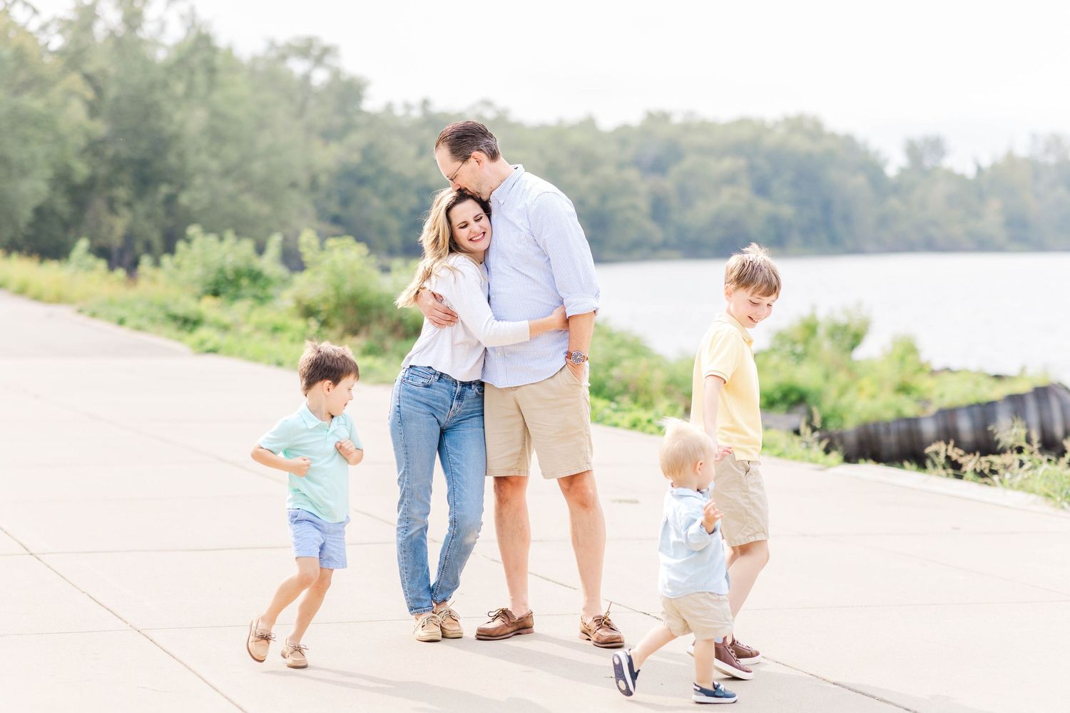 Mom and Dad hugging by the Connecticut River while boys run around -- Minmo Photography