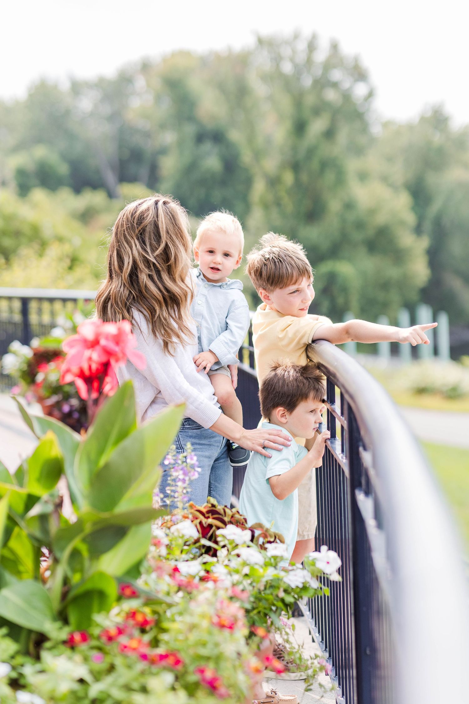 Mom and sons on a balcony during outdoor family photoshoot by Connecticut River — Minmo Photography