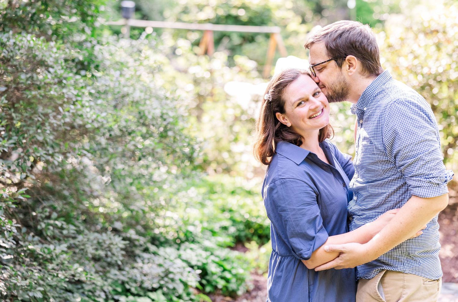 Dad kissing Mom's cheek during a golden hour family session in Connecticut — Minmo Photography