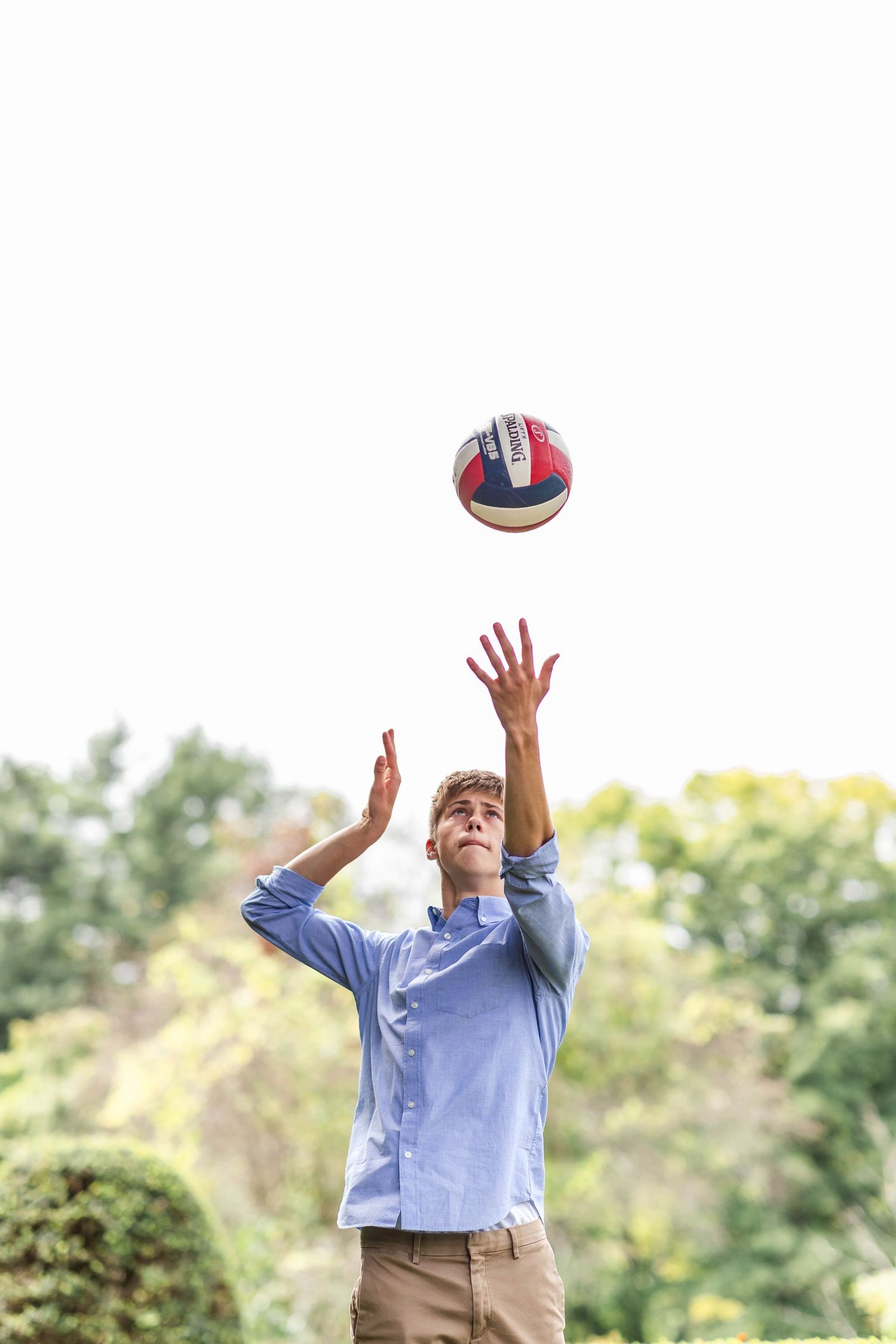 Senior portrait of a young man playing volleyball in Connecticut — Minmo Photography