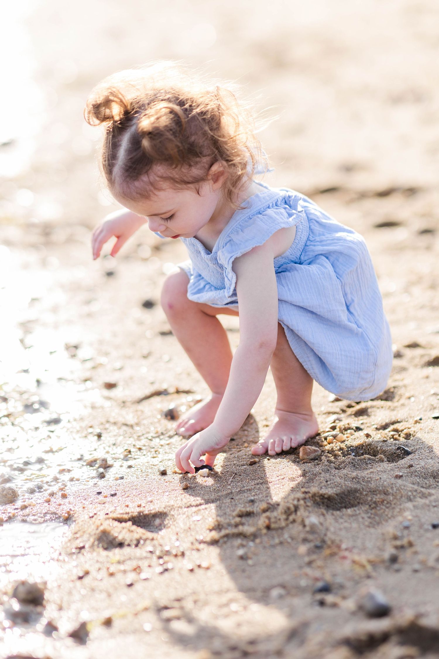 Candid portrait of a toddler playing in the sand during a lifestyle portrait session in Connecticut — Minmo Photography