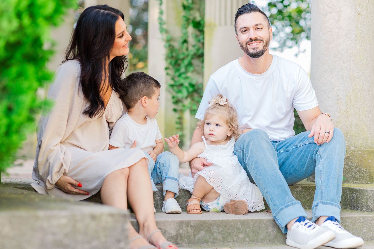 Family of four sitting on the steps at Harkness Memorial State Park during relaxed photoshoot -- Minmo Photography