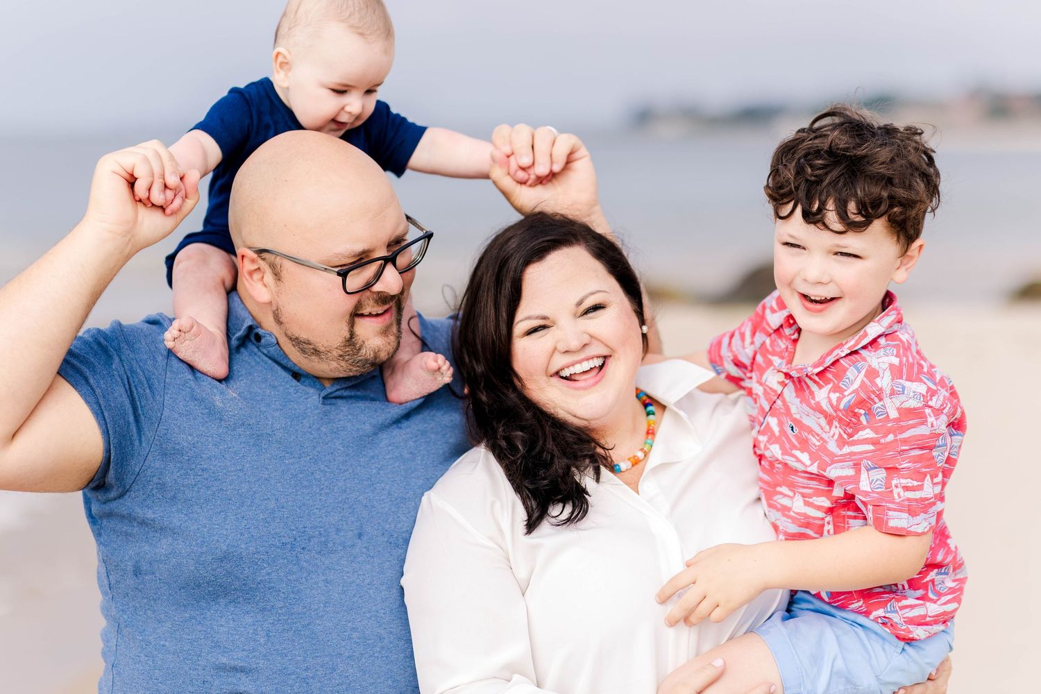 Family laughing together at the beach during a Connecticut family photo session — Minmo Photography