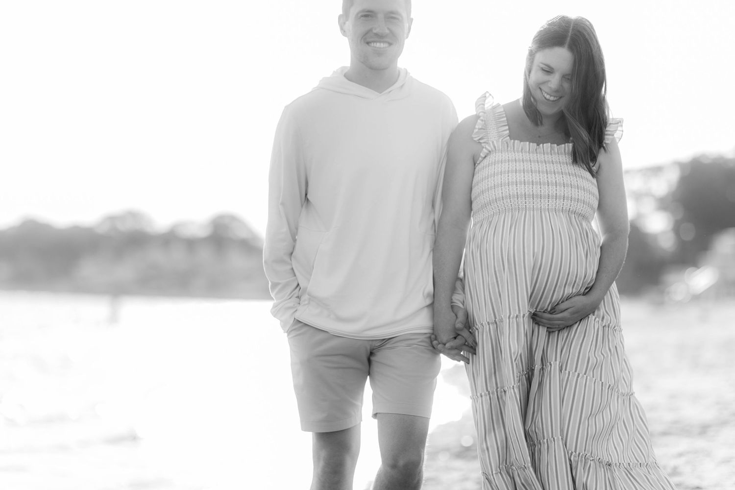 Couple smilng during a Connecticut maternity photography session outdoors — Minmo Photography