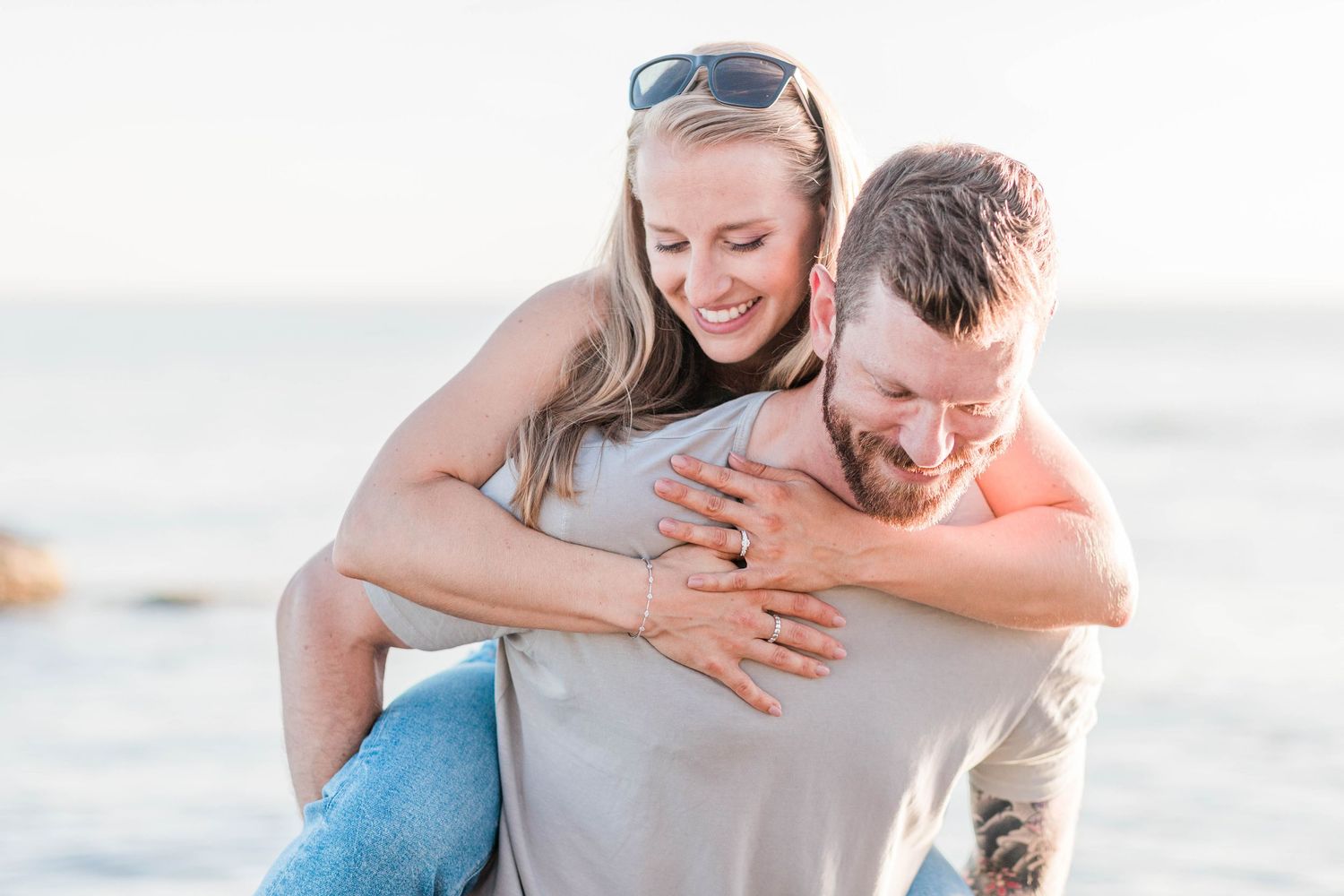 Couple laughing together during a golden hour engagement session in Connecticut — Minmo Photography