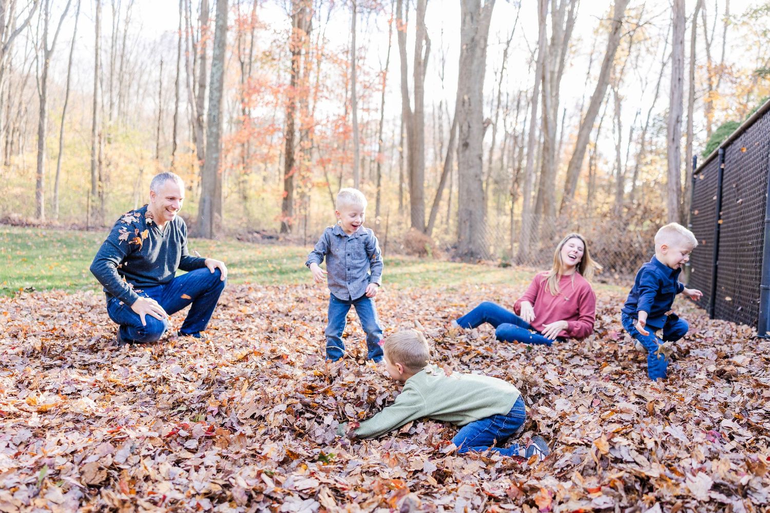 Family of four playing in a Connecticut backyard during a fall family session — Minmo Photography