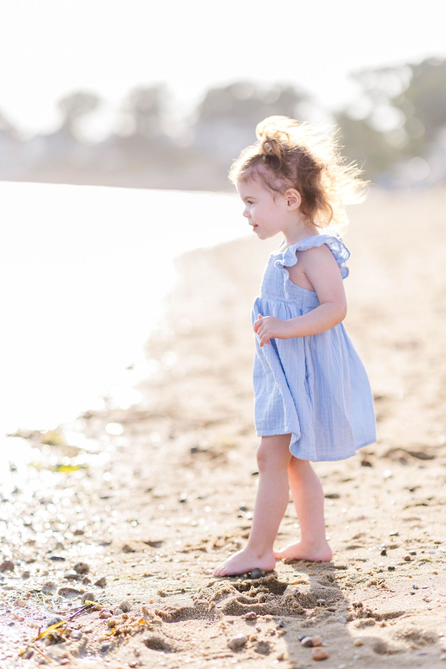 Toddler walking toward the water during family photo session -- Minmo Photography