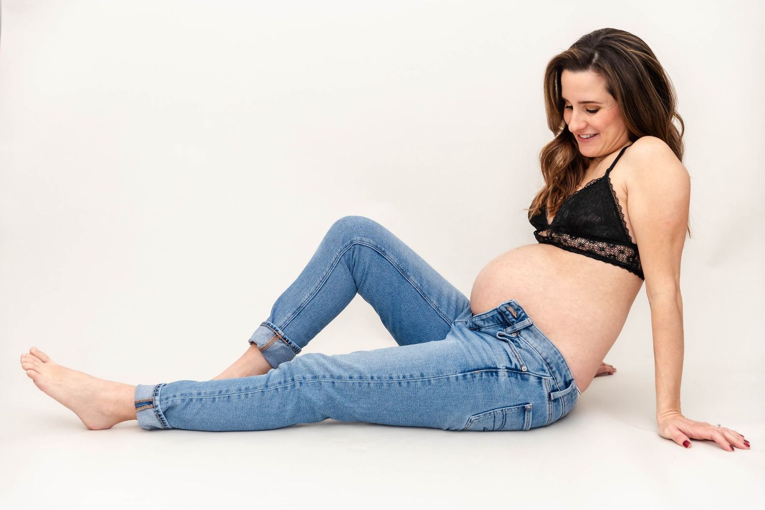 Pregnant woman cradling her belly during a Connecticut maternity session — Minmo Photography