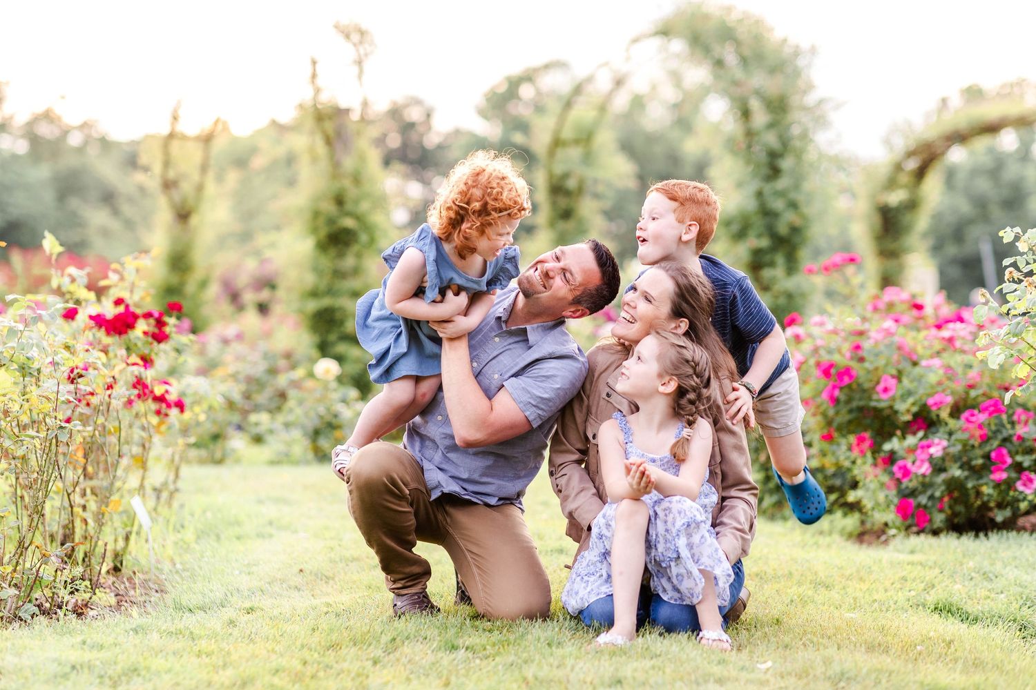 Family playing in the rose garden at Elizabeth Park during a relaxed family session — Minmo Photography